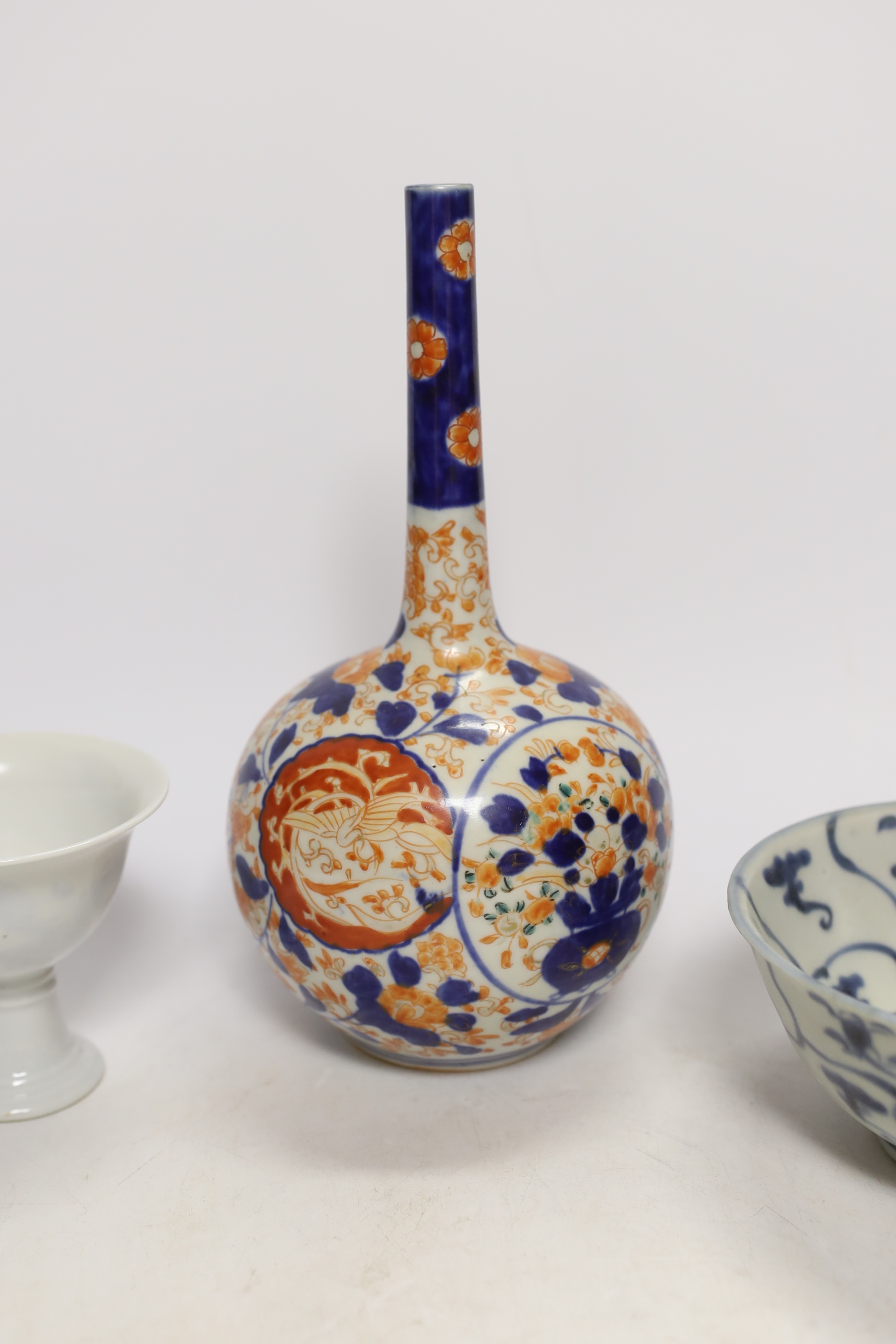 A Chinese Tek Sing Cargo bowl, a Chinese famille Rose Jar and cover, late 19th century, a stem cup with hidden decoration a box and cover and a Japanese Imari bottle vase.